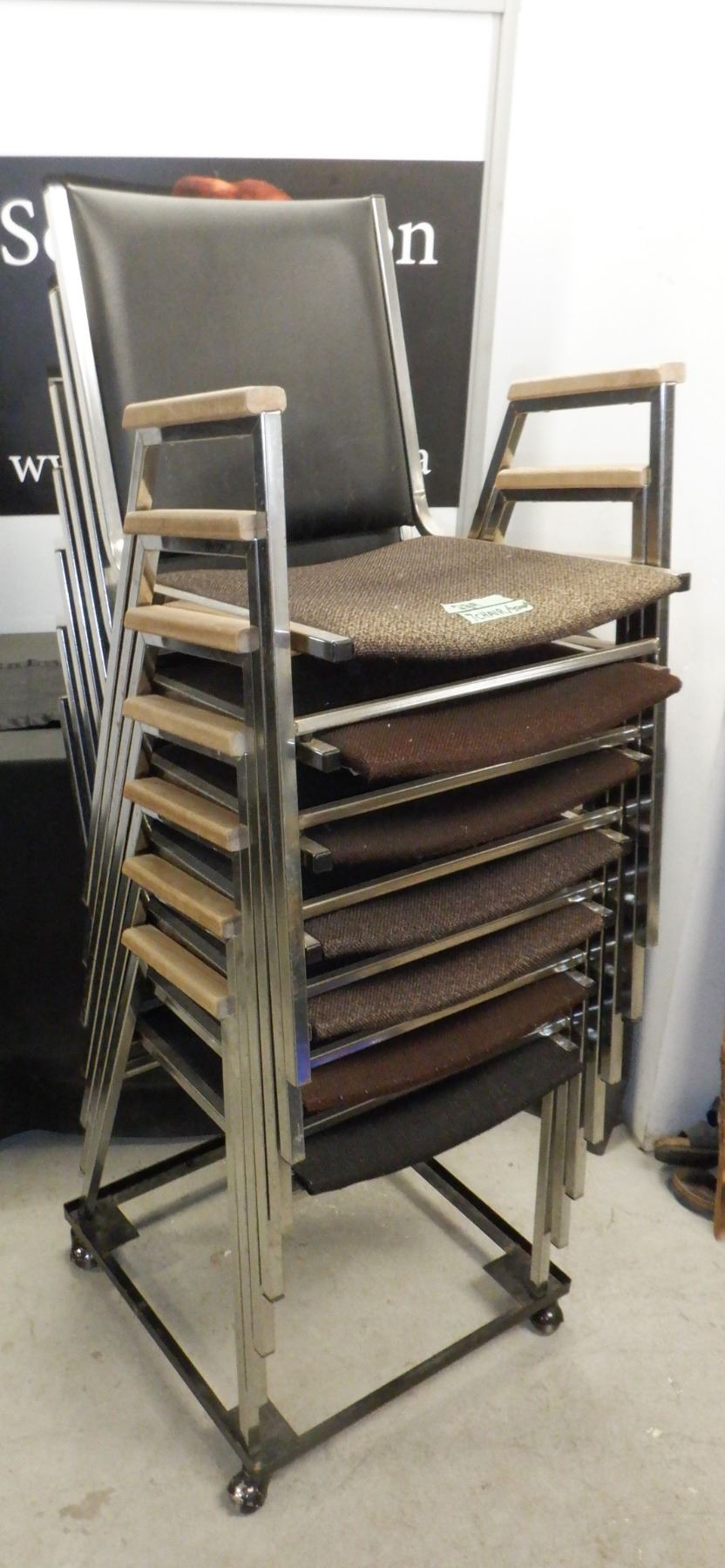 Set of 6 stackable chairs on platform with casters for easy storage and ...
