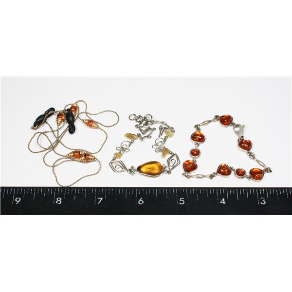 2 AMBER COLORED BRACELETS SOLD WITH GLASSES
