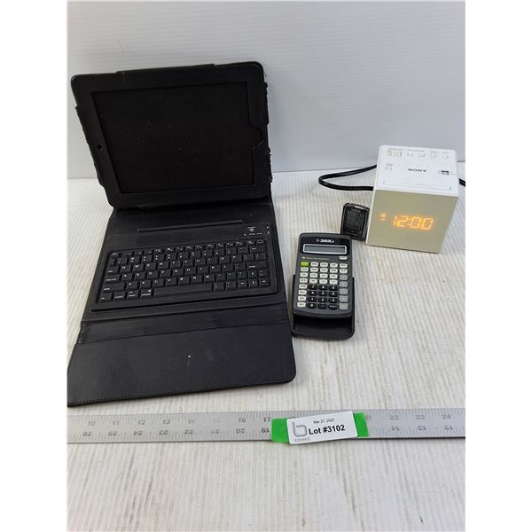 Sony Alarm Clock, Laptop Wireless Keyboard in Case, Texas Instruments Calculatorand Cat Eye Personal