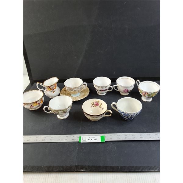 Assorted Tea Cups and a Cream Dispenser