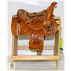 Image 1 : MINI LEATHER SADDLE ON RACK W/UNKNOWN SIGNATURES