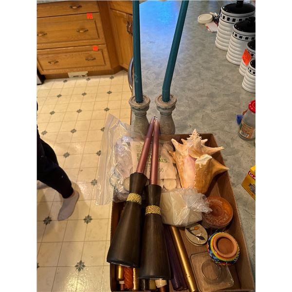 Assorted candles, shell, and trinkets