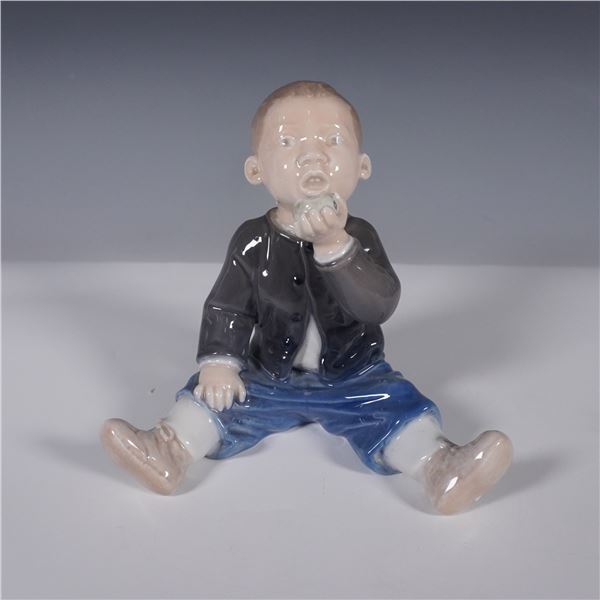 Royal Copenhagen Porcelain Figurine, Seated Boy Eating an Apple