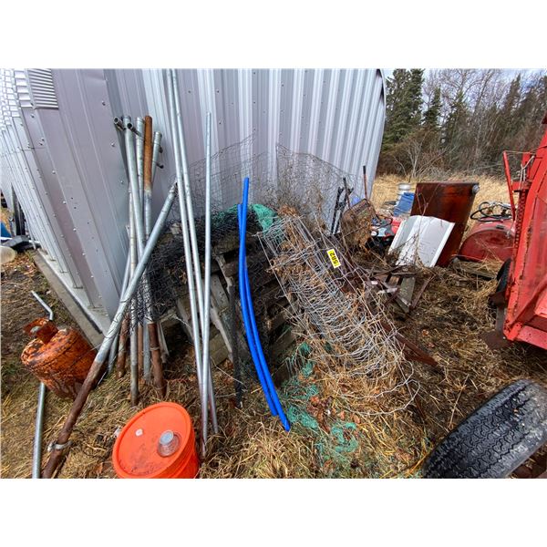 Pile of misc. pipe, mesh, wheel barrow, propane tanks etc.