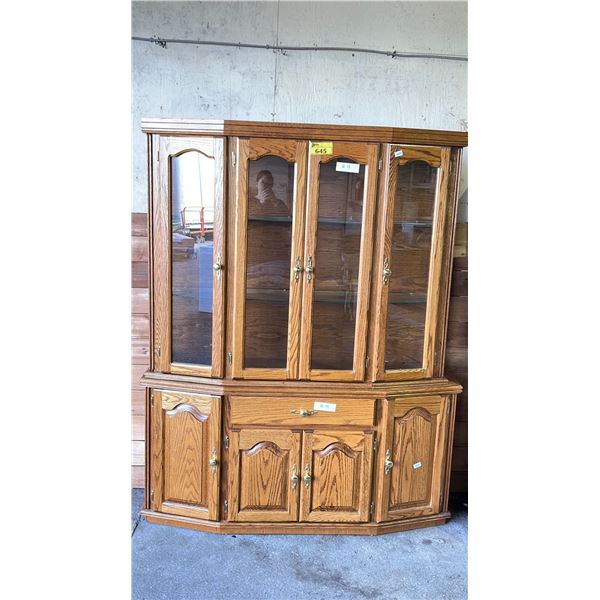 OAK HUTCH AND BUFFET. ANGLE FRONT, LIGHT IN HUTCH. HUTCH 59" X 15" X 47", BUFFET 62" X 16" X 30"