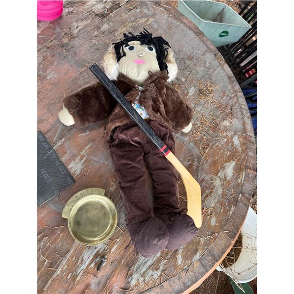 Doll and hockey stick and change dish
