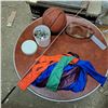Image 1 : 1 deflated foot ball , somewhat deflated basketball, bottle caps, whip and kite.