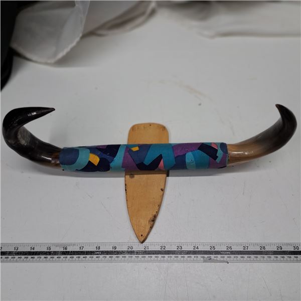 horn on a wooden stand
