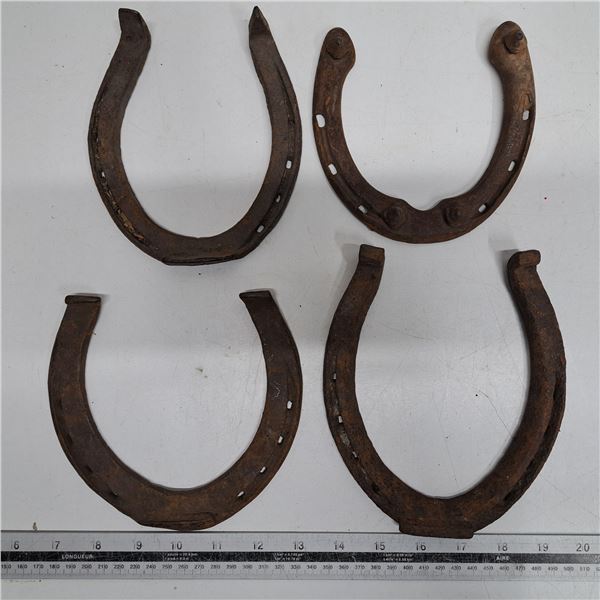 4 various sizes of horse shoes