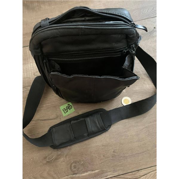 Leather travel bag- lots of compartments , zippers and hidden spots. Crossbody style