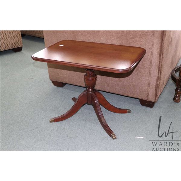 Mid 20th century, Regency style walnut coffee table with center pedestal with brass capped claw feet