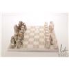 Image 1 : Marble chess board with marble chess pieces etched glass water pitcher and four tumblers and a beer 