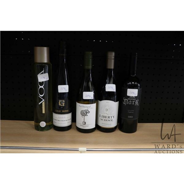 Five assorted bottles of wine including a Voga Moscato 750ml / 7.5% ABV, a Gray Monk Gewurztraminer 