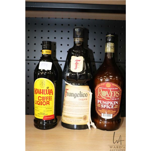 Three bottles of assorted liqueurs including one Kahlua coffee liquor 750ml / 16% ABV, one Frangelic