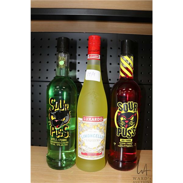 Three assorted bottles of liquor including one Luxardo Limoncello 750ml, one Sour Puss Apple 750ml /