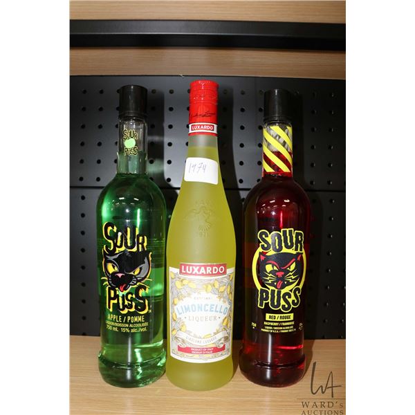 Three assorted bottles of liquor including one Luxardo Limoncello 750ml, one Sour Puss Apple 750ml /