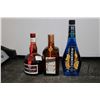 Image 1 : Three assorted bottles of liquor including one McGuiness Blue Curacao 750ml / 15% ABV, one GrandMarn