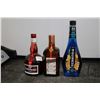 Image 1 : Three assorted bottles of liquor including one McGuiness Blue Curacao 750ml / 15% ABV, one GrandMarn