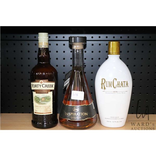 Three assorted bottles of liquor including one Forty Creek Cream Liquor 750ml / 17% ABV, one Zuidam 