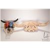 Image 1 : Two horned skulls, one painted and one non-painted with re-glued horn