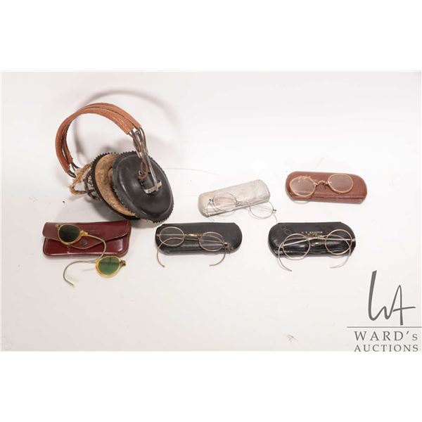 Selection of antique eye glasses, some with possibly gold bridges and a set of vintage headphones