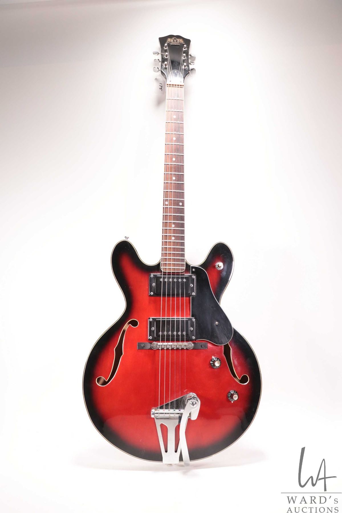 Raven hollow body electric guitar with red burst finish and black pick ...