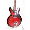 Image 2 : Raven hollow body electric guitar with red burst finish and black pick guard, equipped with Bigsby s