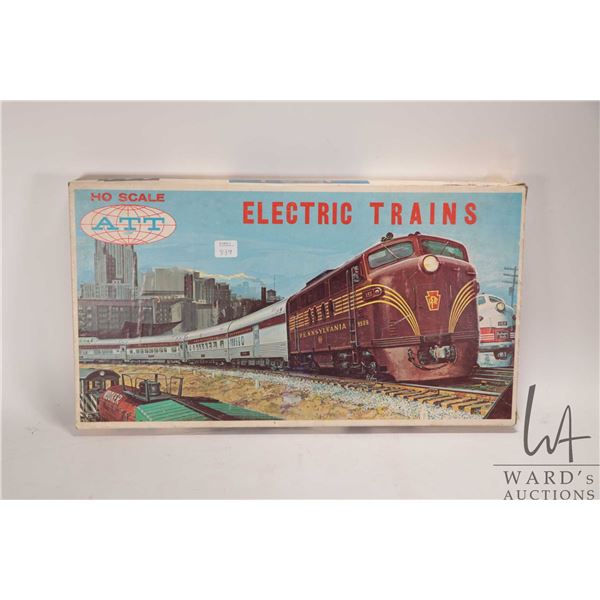 Vintage ATT H.O. scale model train set including power supply, engine, two pieces of rolling stock, 