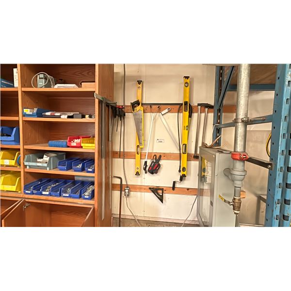 GROUP OF TOOLS ON WALL. TOILET AUGER, BAR CLAMPS, 2X 4' LEVELS, DRYWALL SQUARES, SAWS, ASST