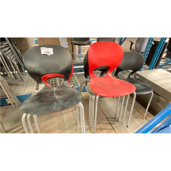 GROUP OF 9 BLACK AND RED STACKING CHAIRS LOCATED IN RACKING NEAR HEAT SEALER.