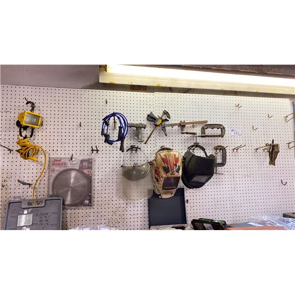 CONTENTS OF PEG BOARD. WORK LIGHT, 2 AUTOMATIC WELDING MASKS, SAW BLADES 10", CLAMPS, WHEEL PULLER