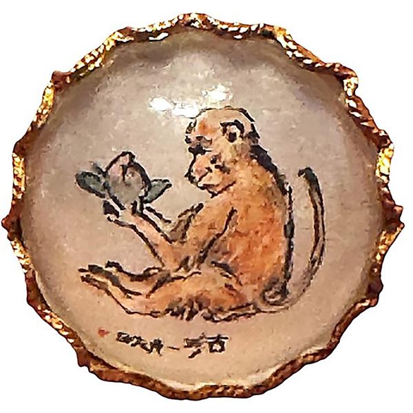 A division three reverse painted glass in metal button