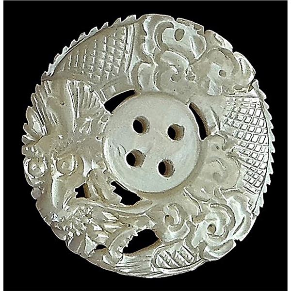 A division one 4 hole sew thru carved pearl button