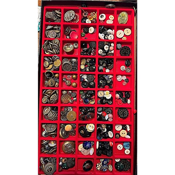 A Riker tray of assorted material buttons