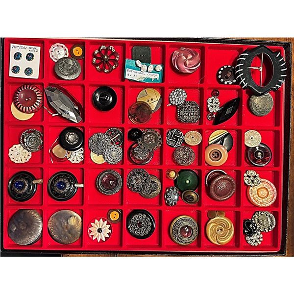 A Riker tray of assorted material buttons