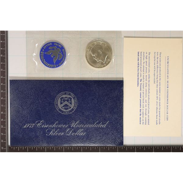 1973 IKE SILVER DOLLAR (BLUE PACK) AND PAPER WORK