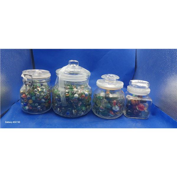 4 glass jars filled with marbles