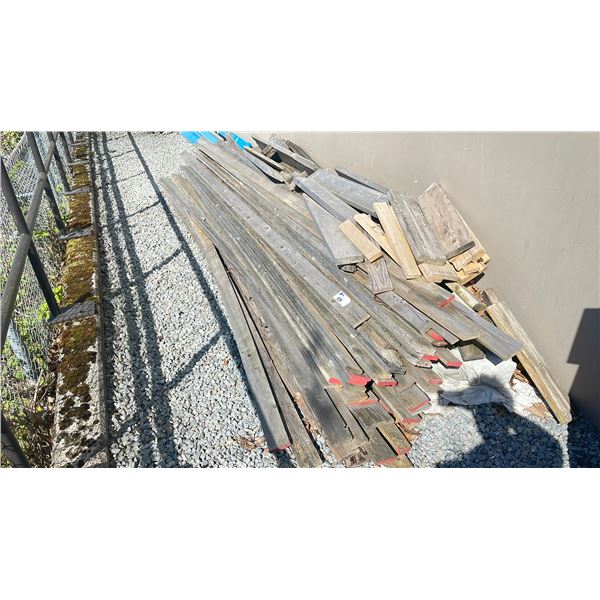 2 PILES OF ASSORTED WOOD OUTSIDE SHOP IN BACK AND PATIO TABLE AND CHAIRS