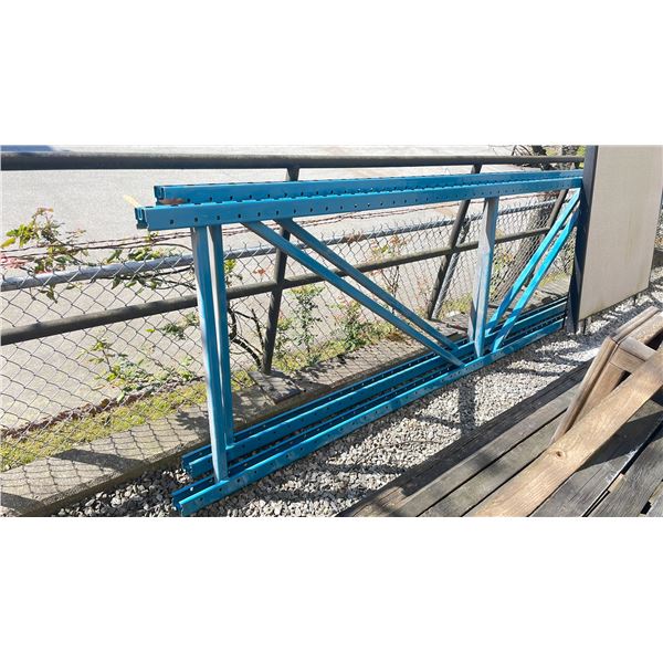 2 BLUE UPRIGHT PALLET RACK  STANDS 112" H AND 6 8 FT BLUE CROSS BARS OUTSIDE BACK SHOP