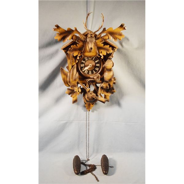 Regular German cuckoo clock, 20" x 14" x 9", with weights, working condition
