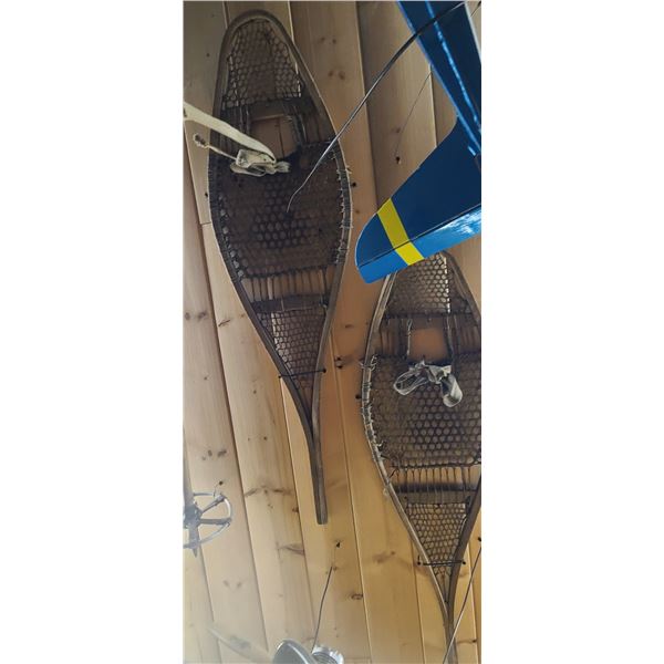 SNOW SHOES AND TWO SETS OF POLES ON CEILING