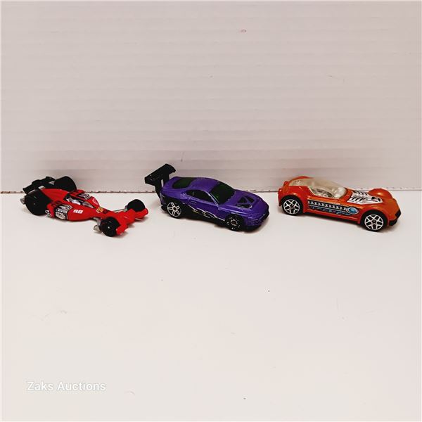 Three Hot Wheels; Team Hot Wheels Nitro Scorcher, Super Tsunami 2001 Purple & Ballstik Orange