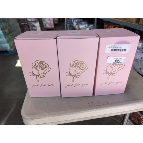 3 ROSES IN DISPLAY CASES