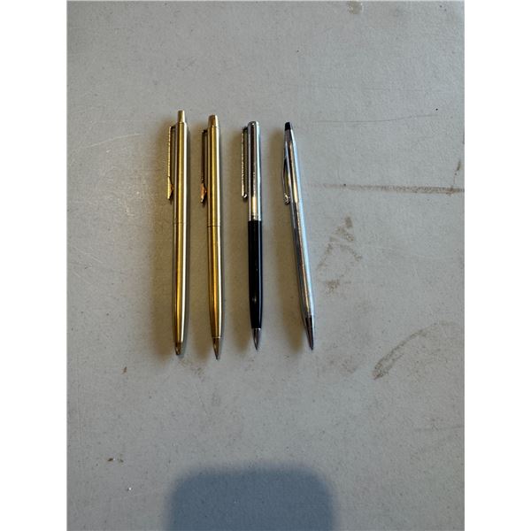 Three paper mate pens, and one cross pen
