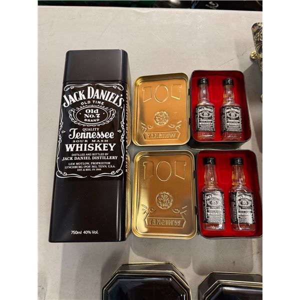 Jack Daniels 750 mil collectible tin and small sealed bottles some maybe evaporated but some have co