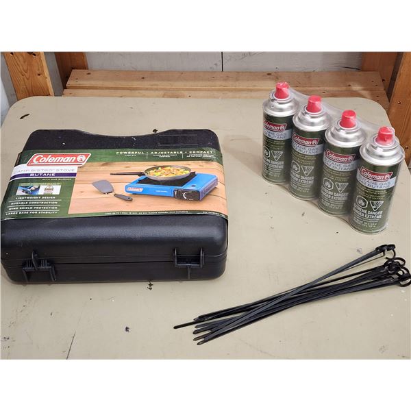 402 -- COLEMAN BUTANE CAMP STOVE WITH FOUR CANISTERS OF BUTANE AND METAL STAKES