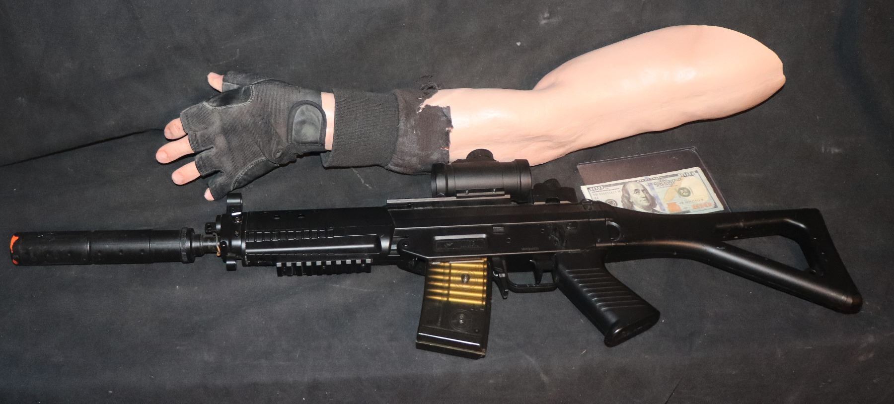 BLACK ADAM ASSAULT RIFLE AND SEVERED ARM WITH GLOVE