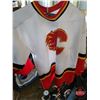 Image 8 : Pallet Lot - Variety Hockey Gear : Selection of Skates; Pads; Gloves; Ref Gear; Pucks; Flames Jersey