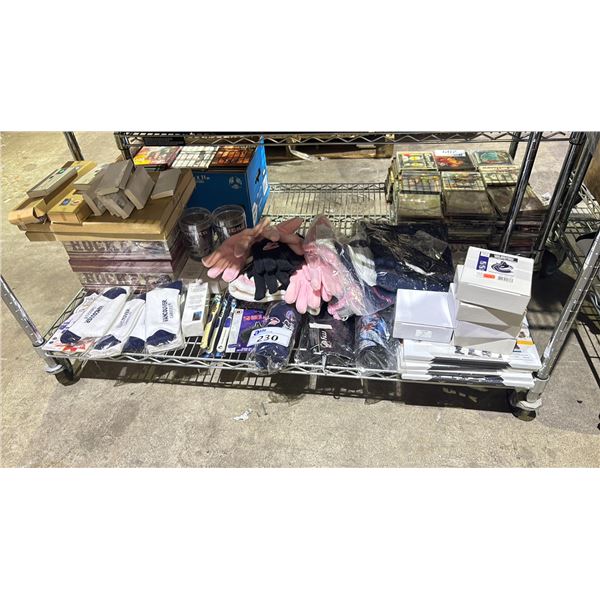 SHELF OF VANCOUVER CANUCKS ITEMS INCLUDING GLOVES, SOCKS, STEAK KNIVES, CUTTING BOARDS, WATER