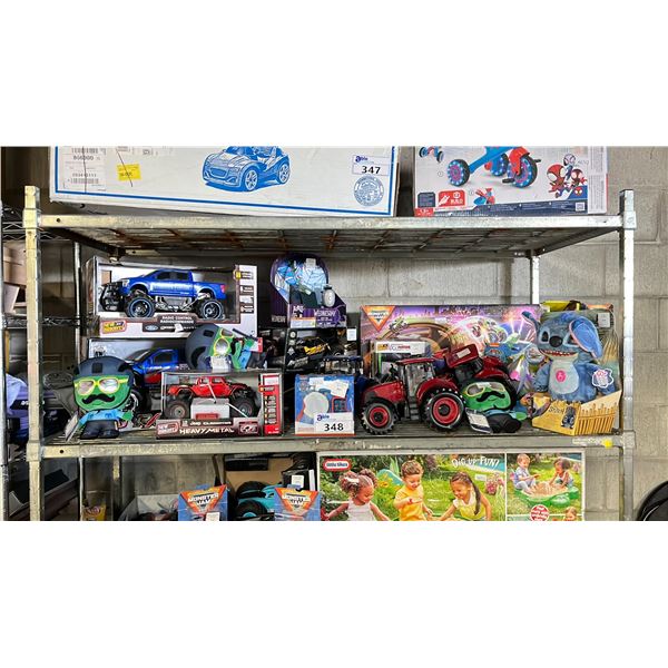 SHELF OF ASSORTED TOYS INCLUDING; RC MONSTER TRUCKS, STITCH STUFFY, MONSTER JAM SUPERCHARGE